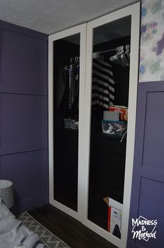 a bedroom with purple walls and white closet doors