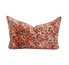 an orange and pink pillow with floral designs on the front, sitting against a white background