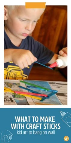 a young boy is making crafts with craft sticks