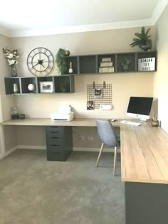 a desk with a computer on top of it and some shelves above the desk in front of it