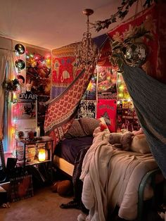 a bedroom with lots of hanging decorations and lights on the walls, including a hammock bed