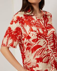 Oversized with a relaxed fit, this short-sleeve button-down comes in silk viscose, chosen for its easy, lightweight drape and soft hand-feel. The Oversized Short Sleeve Button Up Shirt is styled with the Silk Wide Leg Drawstring Pant. Relaxed Fit Rayon Blouse For Vacation, Vacation Rayon Blouse With Relaxed Fit, Short Sleeve Rayon Shirt For Beach, Rayon Short Sleeve Shirt For Beach, Relaxed Fit Rayon Shirt For The Beach, Relaxed Fit Rayon Shirt For Beach, Summer Silk Shirt With Button Closure, Silk Summer Shirt With Button Closure, Silk Shirt With Button Closure For Summer