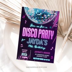 a disco party flyer is displayed on a plate with a fan in the back ground