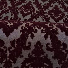 an upholstered velvet fabric with floral design