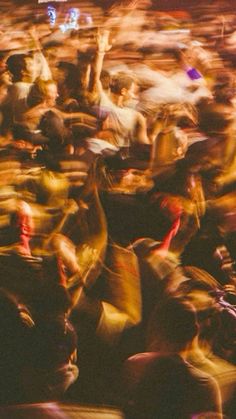 blurry photograph of people dancing at an outdoor concert