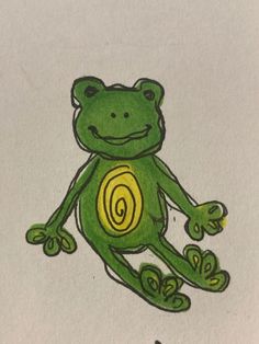 a drawing of a green frog sitting on top of a piece of paper with the letter g in it's center