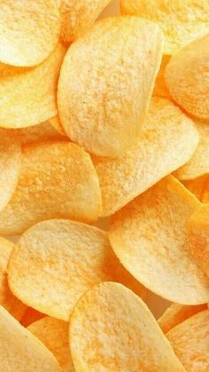 yellow potato chips are piled on top of each other