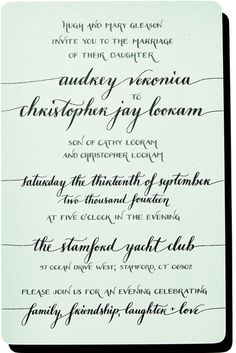 an ornate wedding card with black ink and calligraphy on the front, in white paper