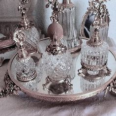 an assortment of glass items on a silver tray