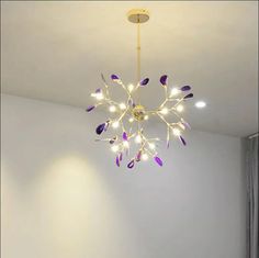 a chandelier hanging from the ceiling in a room with white walls and flooring