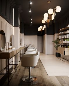 an empty salon with chairs and lights hanging from the ceiling