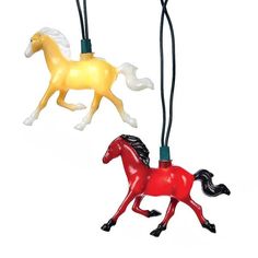 two small plastic horses are hanging from strings on a white background, one is yellow and the other is red