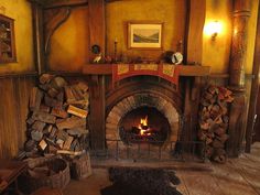 a fireplace with logs stacked on top of it and a fire place in the middle