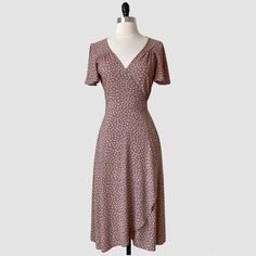 A Timeless Classic, The Coffee Date Wrap Dress Features Airy Short Sleeves, Elegant Tailored Detailing And A Curved Hemline. Crafted In A Soft Neutral Rayon With Abstract Coffee Bean Print Throughout. This Piece Will Be A Go-To Style In Your Closet And Can Easily Be Worn From Day To Night. Unlined But Opaque. 100% Rayon Hand Wash Or Dry Clean Color: Dusty Rose Made In California Fitted Mid-length Brown Dress, Brown Fitted Mid-length Dress, Brown V-neck Ruffled Midi Dress, Brown V-neck Midi Dress With Ruffles, Brown V-neck Dress For Garden Party, Fitted Brown Midi Dress With Ruffles, Brown Ruffled Dress For Garden Party, Taupe Fitted V-neck Dress, Fitted Brown Midi Dress For Garden Party