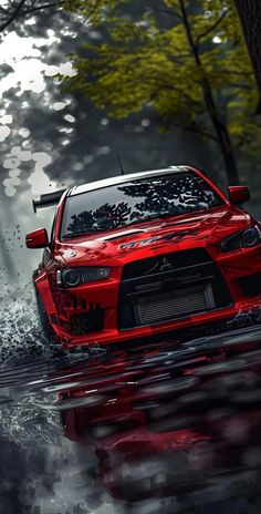 a red car is driving through some water