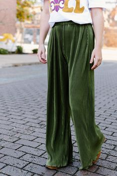 Look your absolute best with these olive green pleated pants. Crafted from a stretchy and ultra comfortable fabric with an elastic waistband, these pants offer a flattering, high waisted fit and elegant pleated design for a sophisticated, yet effortless look. Feel confident and beautiful in these flowy bottoms! Elastic waistband and high waisted Runs true to size with lots of stretch 100% Polyester model, Lauryn is wearing a size small Chic Olive High Waist Bottoms, Olive Spring Trousers, Spring Olive Trousers, Olive High-waisted Pants For Spring, Chic Olive High-waisted Pants, Olive Bottoms With Elastic Waistband For Spring, Chic Olive Bottoms For Spring, Chic Olive Pants For Spring, Chic Olive Trousers