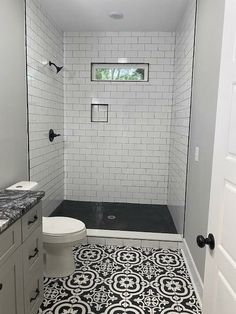 a bathroom with black and white tile flooring