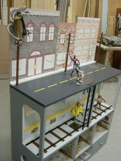 two toy figurines are standing on top of a shelf in a room that is being constructed