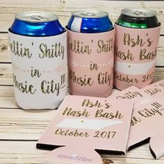 pink and gold wedding can coolers with matching coasters on wooden table next to each other