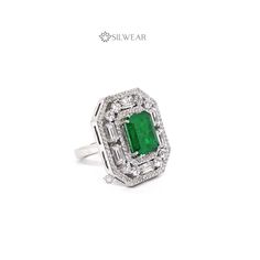 Emerald Doublet and American Diamond Cocktail ring, Exquisite 925 Sterling Silver Designer Jewellery, Gemstone Wedding Ring, Engagement ring Product Details :- CATEGORY : Cocktail Ring STYLE : Contemporary METAL : 925 Sterling Silver GEMSTONES / DECORATIONS : High-Quality Emerald Doublet & Simulated Diamond with American Diamonds. RING SIZE : Choose your size from the provided options. RING RESIZABLE : Yes GROSS WEIGHT : 15 gm apx. PLATING : Rhodium plating FEATURES : 1) Exclusively hand-process Silver Emerald Ring With Prong Setting, Dazzling Silver Emerald Ring With Prong Setting, Dazzling Silver Emerald Ring With Round Cut, Formal Green Cubic Zirconia Halo Ring, Formal Silver Emerald Ring Baguette Cut, Silver Emerald Ring With Cubic Zirconia Center Stone, Emerald Cubic Zirconia Ring With Center Stone, Silver Baguette-cut Emerald Ring For Wedding, Dazzling Green Diamond-cut Rings