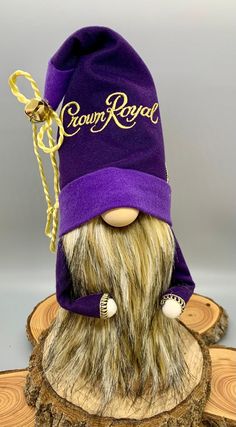 a purple beanie hat with the word crown royal on it and a long beard