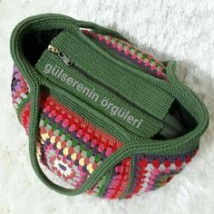 a green crocheted bag sitting on top of a white carpet