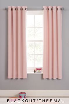 the pink curtains are hanging in front of the window