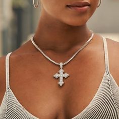 Introducing the Iced Gothic Cross in White Gold - a stunning addition to your pendant collection. Crafted with a durable 14k White Gold finish and hand-set stones, this cross is guaranteed to make a statement! Pair this piece with our 3mm Tennis Necklace in White Gold for a complete, elevated look. This product is guaranteed for life - GLD will repair the item should you experience any defects in craftsmanship or breakage. Specifications - 35mm x 42mm (Width x Height) - Bail: Fits up to 5mm Tenn