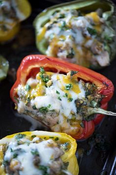 stuffed bell peppers with cheese and herbs on them