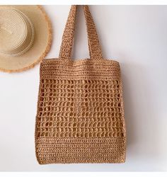 a straw bag next to a straw hat