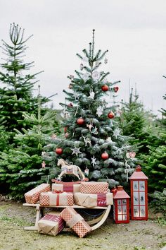 a christmas tree with presents in front of it