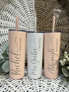 three personalized tumblers sitting on top of a wicker basket