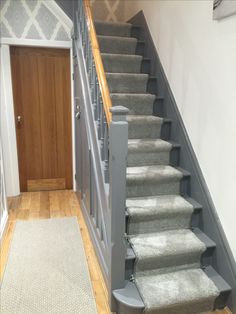 a staircase with carpeted steps leading up to the door