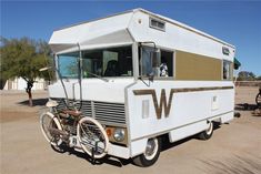 an rv with a bike attached to the front