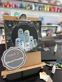 a blackboard with ghost pictures on it next to markers and paintbrushes in the background