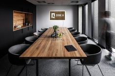 an empty conference room with wooden table and chairs