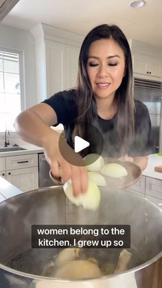 a woman is cooking in a large pot