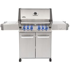 an outdoor grill with four burners and two blue bottles on the side, against a white background