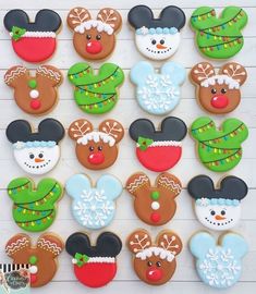 mickey mouse christmas cookies decorated with royal icing and frosting on a white wooden surface