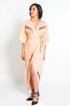 Make an entrance in our super sleek, figure-loving kimono wrap dress. Our top selling wrap dress is hand beaded with peacock feathers that will be sure to get you noticed and bring oodles of compliments everywhere you go. The romantic blush color is sure to make you fall head over heels in love, while our super soft natural fabric ensures comfort all day long. FIT This dress fits true to size and is based on Anthropologie's sizing. Please refer to our size guide below to ensure you choose the ri Beaded Peacock Feather, Feather Kimono, Beaded Peacock, Slow Fashion Clothes, Blush Outfit, Head Over Heels In Love, Kimono Wrap Dress, Kimono Wrap, Tulip Skirt