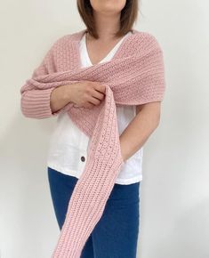 a woman wearing a pink knitted scarf