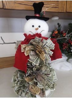 a snowman made out of money sitting on top of a counter