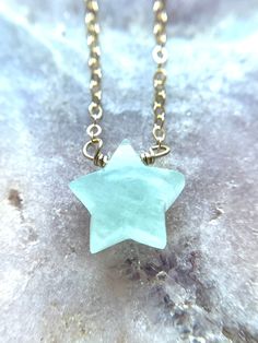 A Star carved polished piece of Aquamarine has been organically cut and polished into a beautiful natural aquamarine star pendant and has been paired on a Sterling silver or 14k gold filled chain. This gorgeous aquamarine crystal is perfect for layering and everyday wear. Handcrafted Aquamarine star Pendant Necklace *Powerful throat chakra stone -- calming, soothing, and cleansing *Stones offer stunning unique characteristics *Soothing shades of Blue *Each stone measures approx 12x12mm *Aquamari Aquamarine Jewelry Necklace, Handmade Pearl Necklace, Cleansing Stones, March Birthday, Birthday Jewelry, Aquamarine Necklace, Velvet Jewelry, Star Pendant Necklace, Aquamarine Crystal