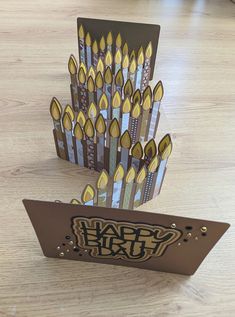 a birthday card with candles on it and the words happy birthday written in black ink