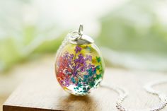 a glass pendant is sitting on a wooden surface