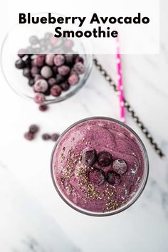 blueberry avocado smoothie with sprinkles and berries in the background