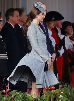 the duke and princess of cambridge are standing next to each other in front of some people