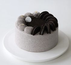 a white plate topped with a cake covered in chocolate frosting