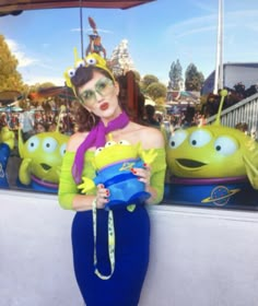 a woman is posing for a photo in front of an amusement park scene with her hands on her hips