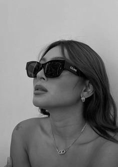 a woman wearing sunglasses is posing for the camera